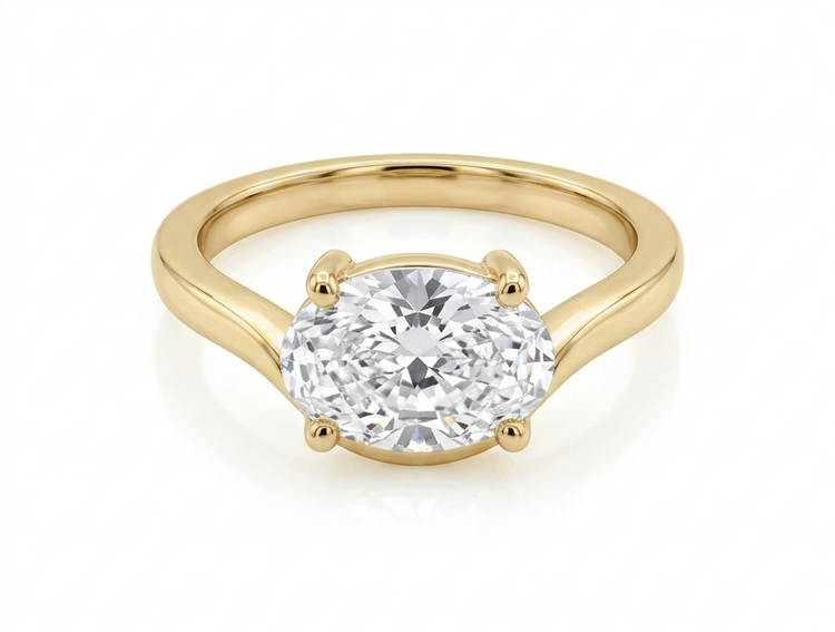 Gold ring with a diamond on a white background