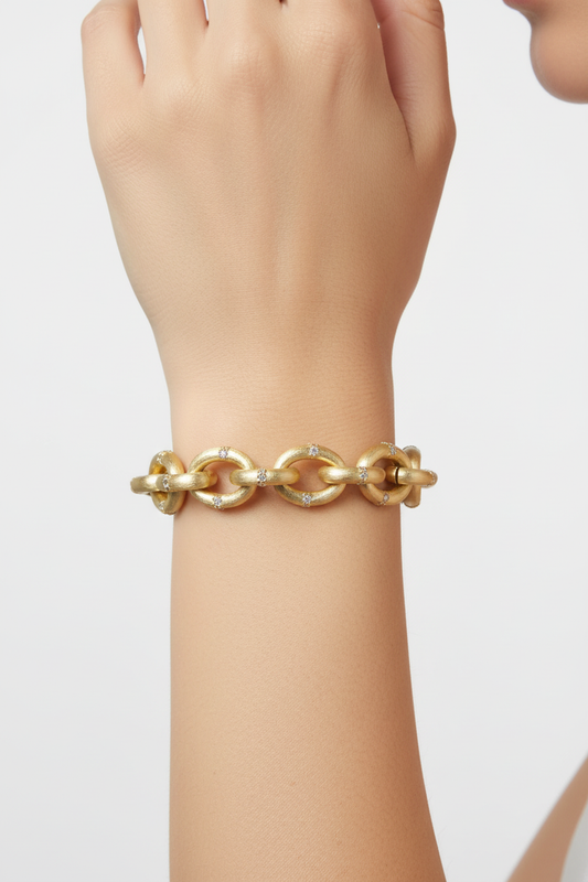 Gold chain link bracelet on woman's wrist